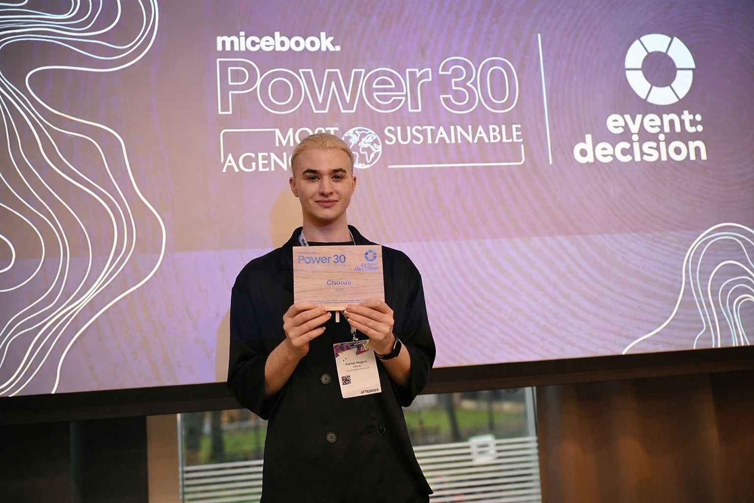 Aarron McGurk on stage collecting Chorus’s micebook Power 30 Most Sustainable Agencies award
